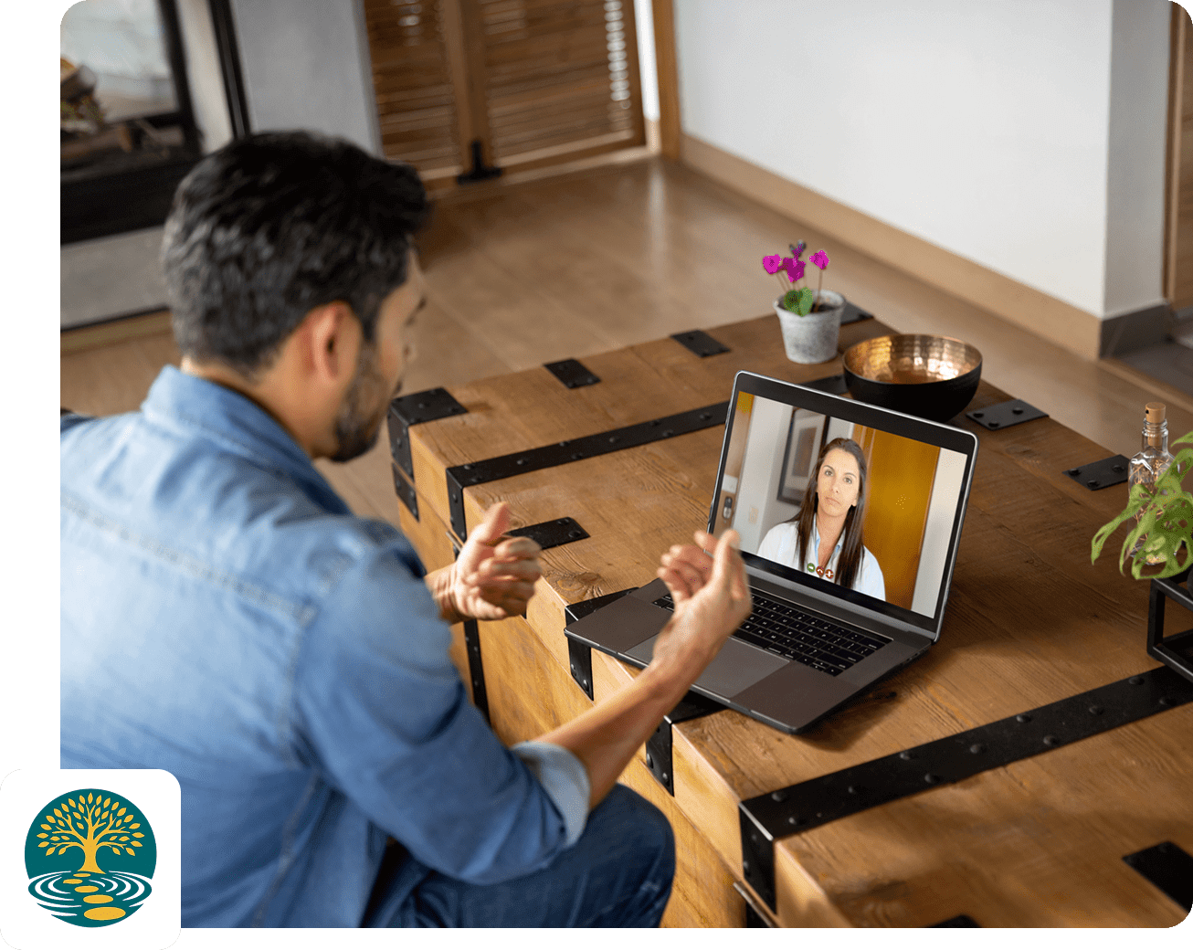 Man video chatting on laptop at home