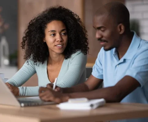 Two people engaged in a focused study session together.