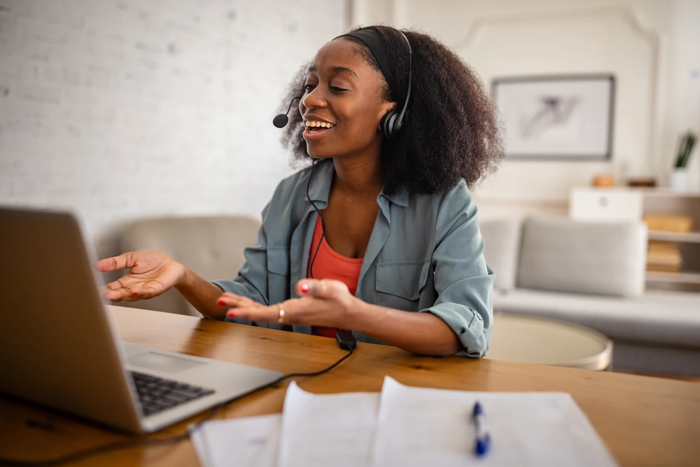Woman smiling and talking during a video call at home.