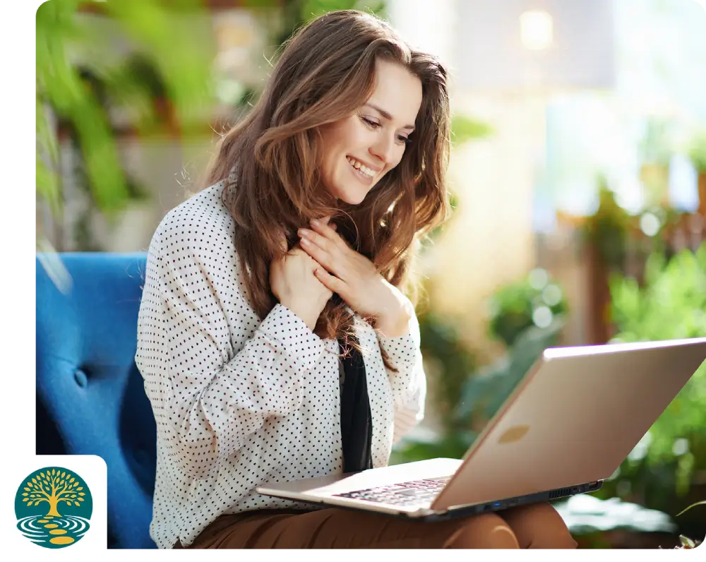 Smiling woman using a laptop